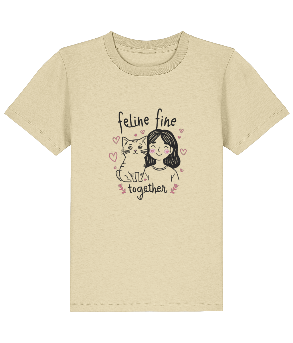Beige t-shirt with a graphic of a woman and cat with 'feline fine together' text on a white background